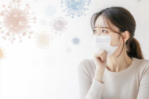 A Korean woman wearing a white mask, looking worried as she sits at a desk with her hand on her chin. The background is a minimalist white space with faint virus symbols in pastel colors, leaving empty space for text or graphics